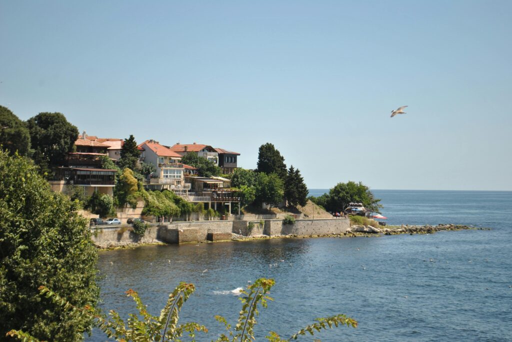 Picturesque cliffside view of a seaside village with clear blue ocean.